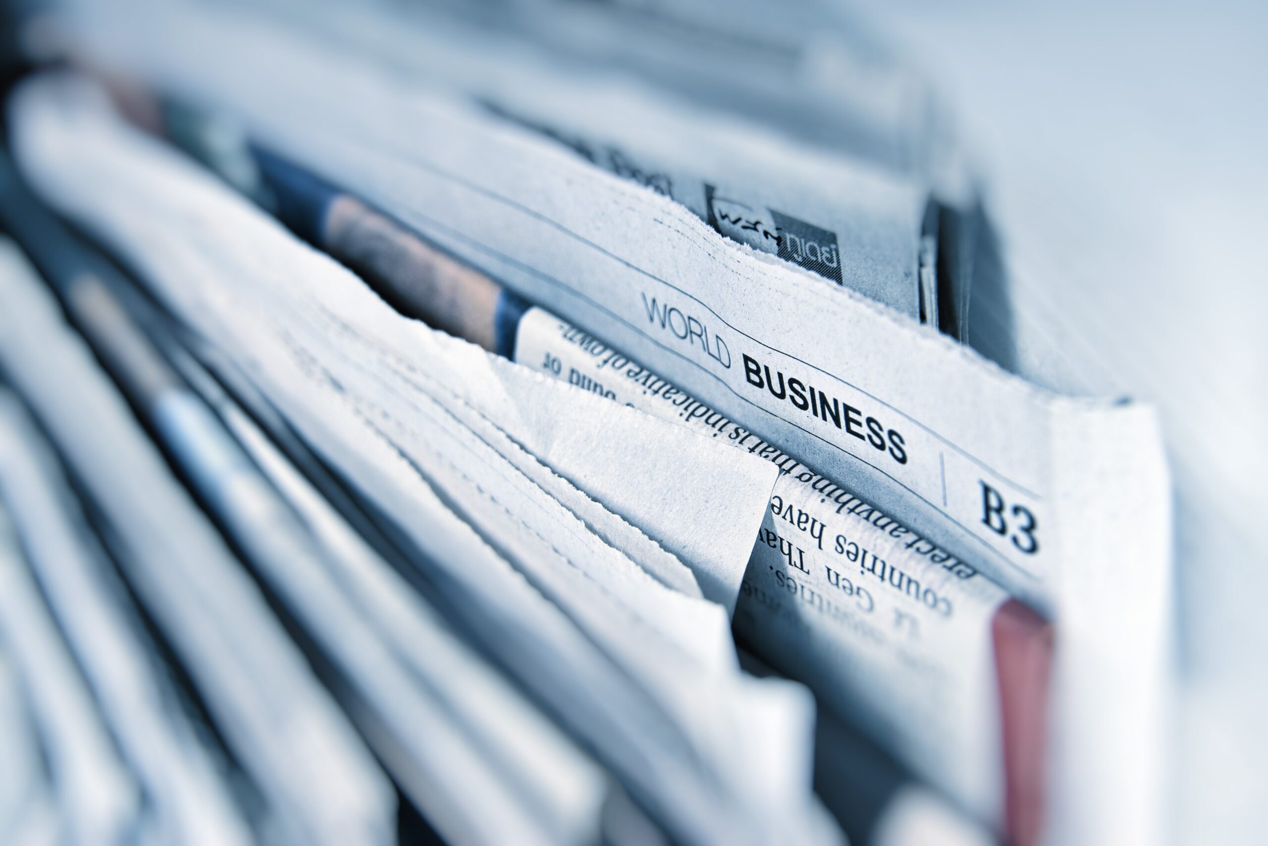 Featured blog post image of a newsletter with the business section highlighted to support Lindsay Smith's regular blog posting about newspaper headlines and real estate.