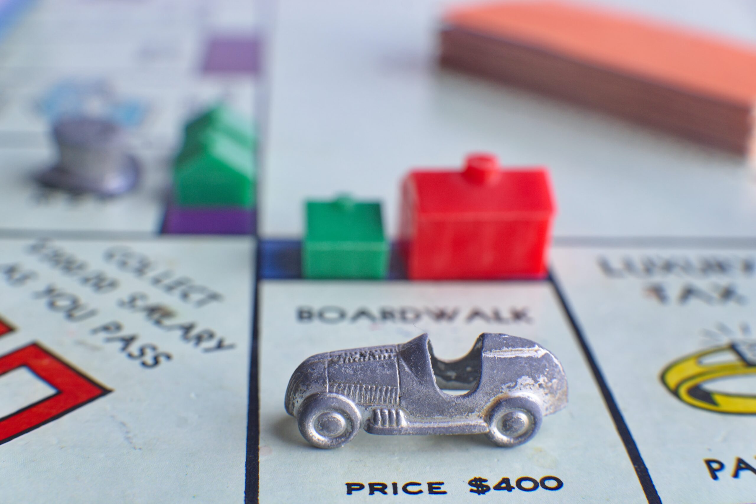 Monopoly game pieces used to illustrate the weekly Buy Sell Love Durham blog post about rising interest rates for mortgages.